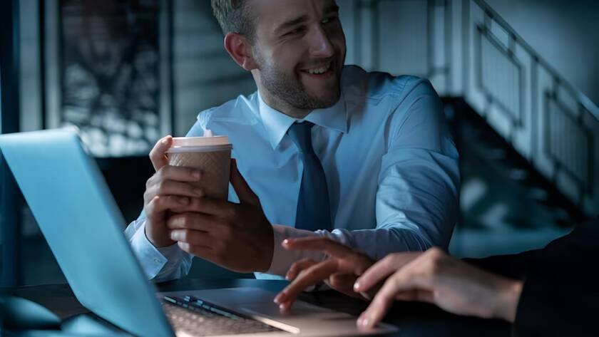 office manager man drinking coffee smiling his business partner laptop with cup coffee office female 2