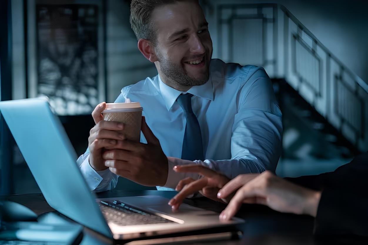 office manager man drinking coffee smiling his business partner laptop with cup coffee office female 2