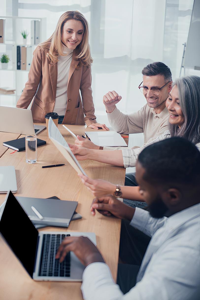 stock photo selective focus smiling multicultural colleagues looking folder meeting